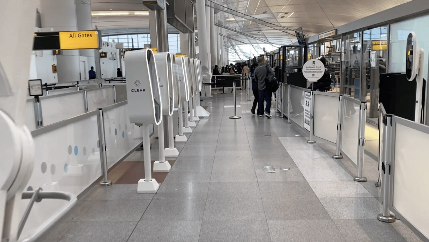 a row of clear kiosks at the airport 