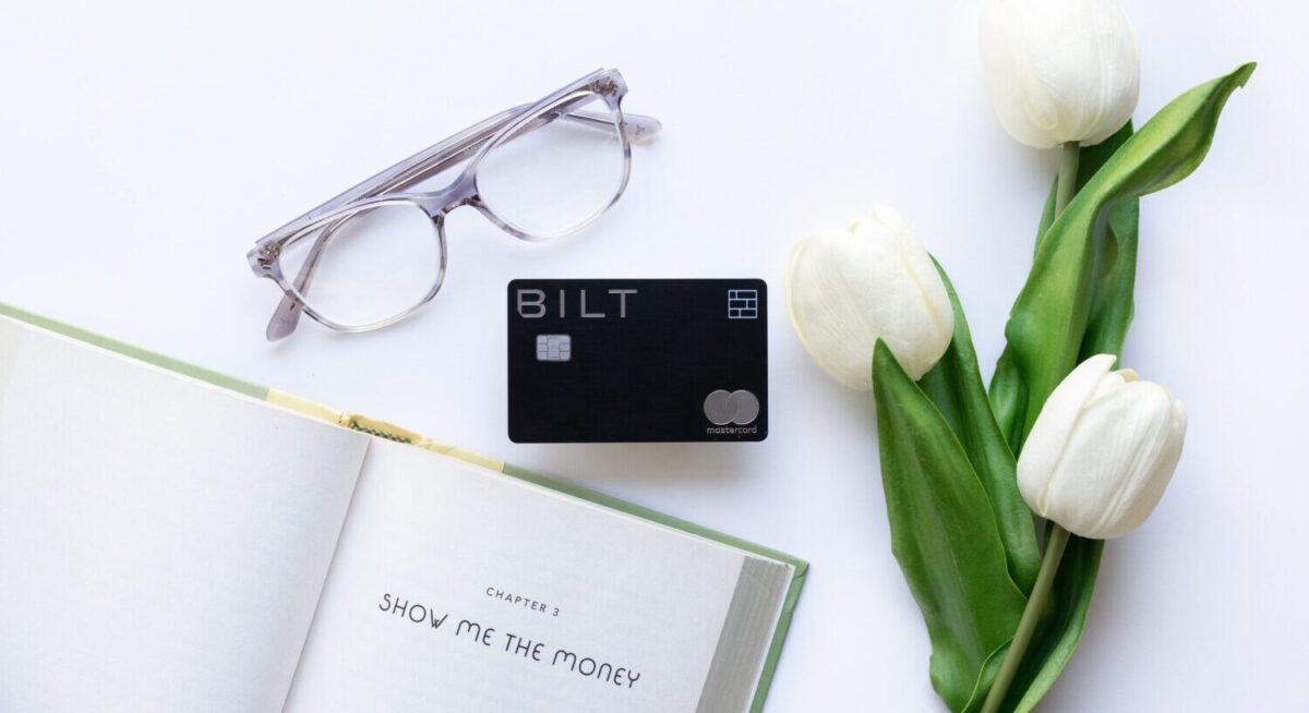 Bilt Mastercard with an open book, pair of glasses, and roses.