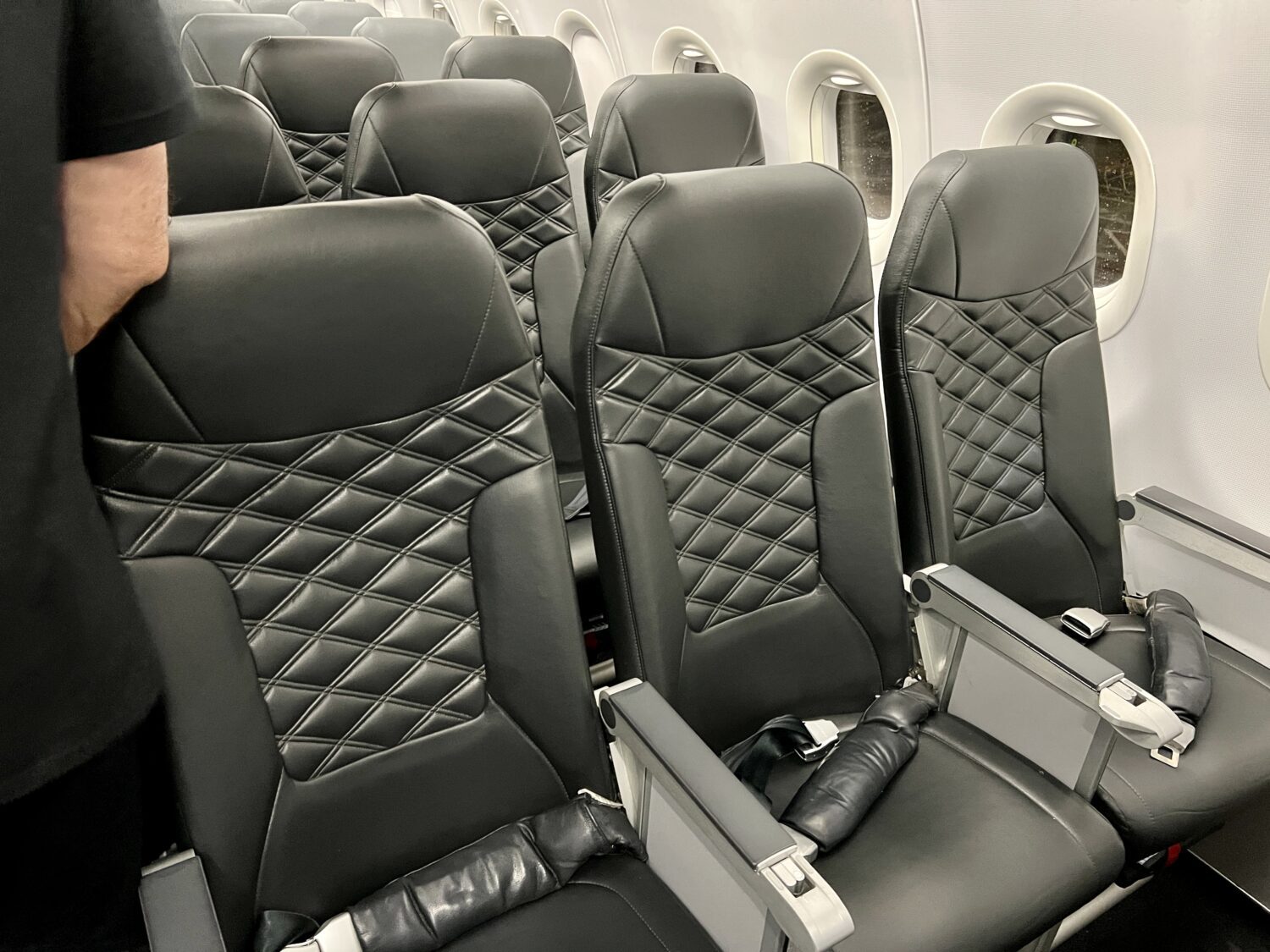 black airplane seats in an exit row 