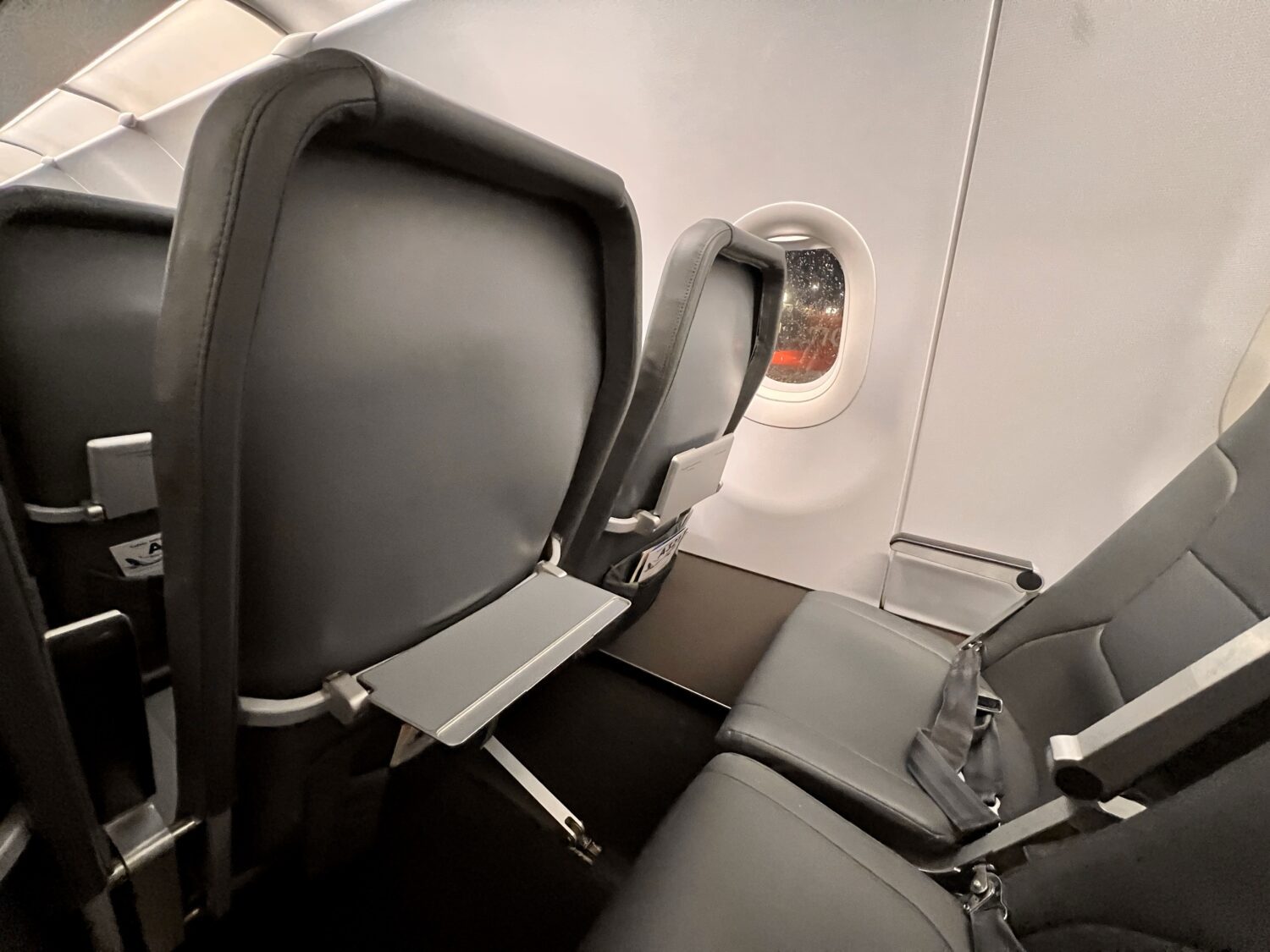 a small tray folded down on the back of an airplane seat