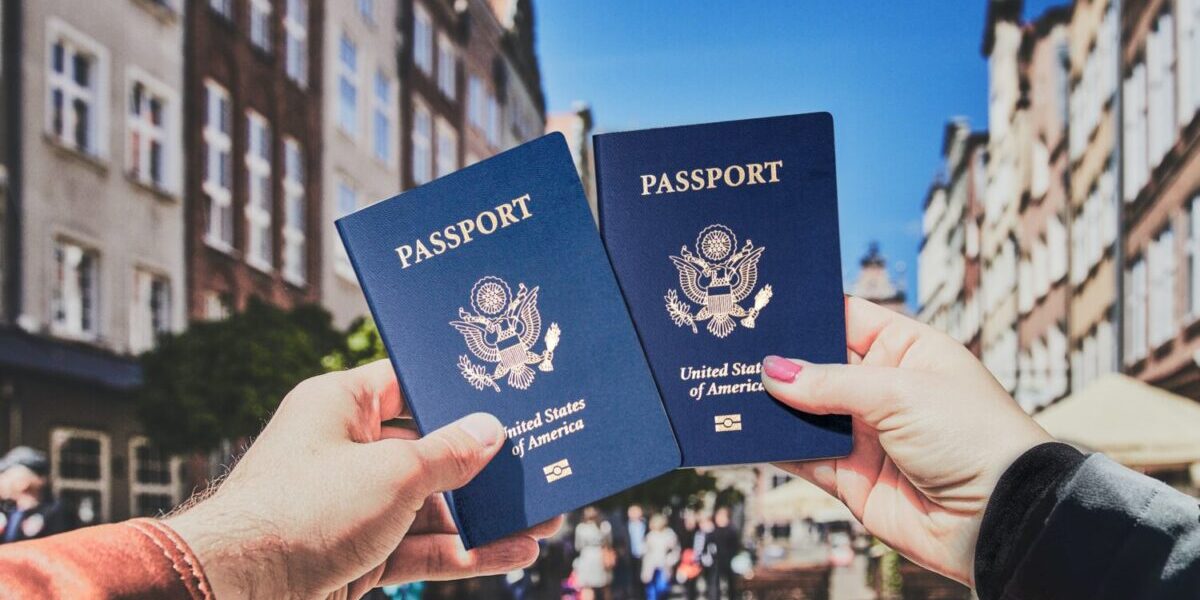 couple holding up their US passports