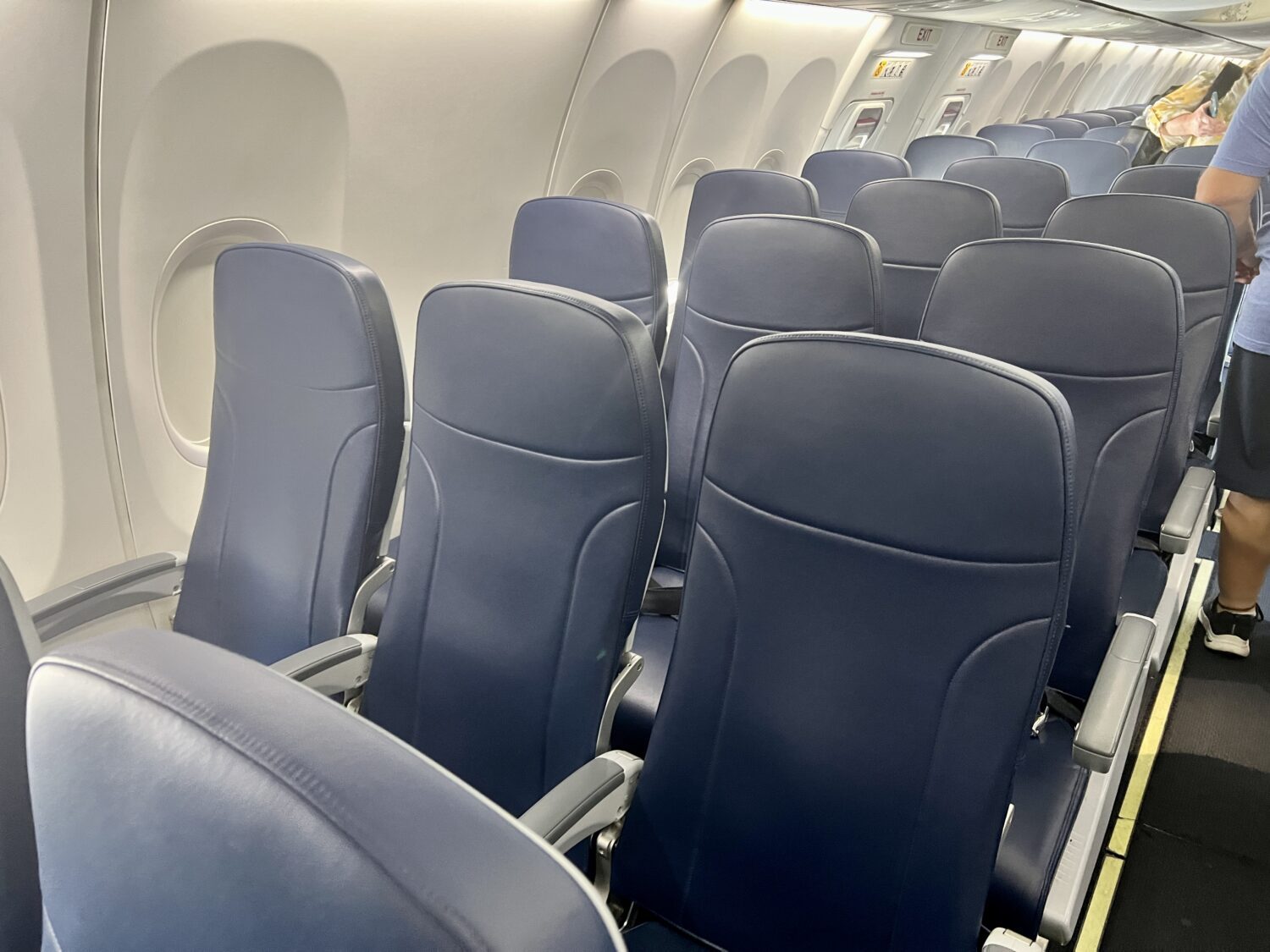 several rows of blue leather airplane seats