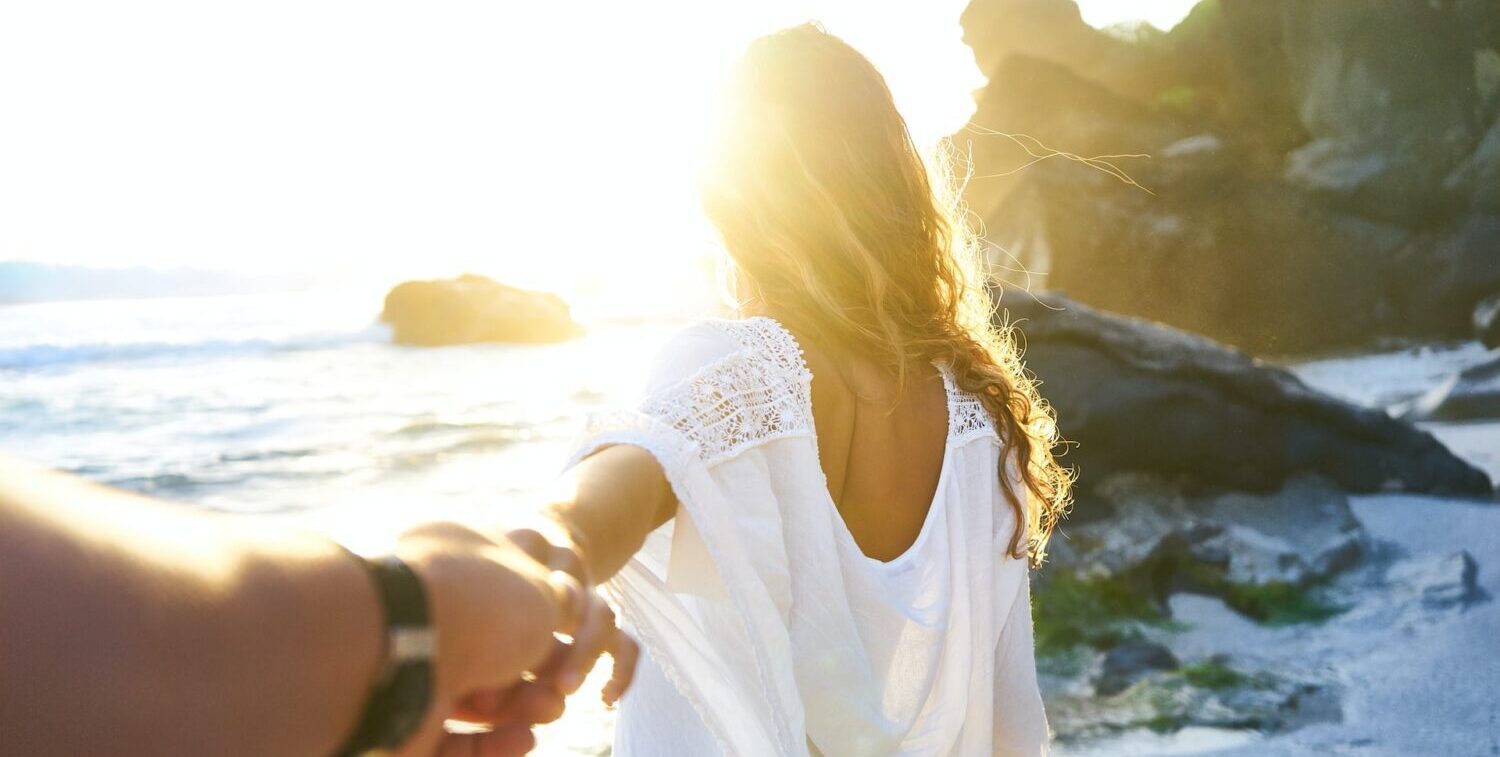 couple holding hands on the beach