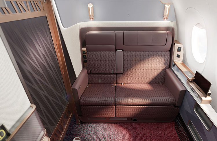 japan airlines first class suite with extra large seat, sliding door, and touchscreen control panel