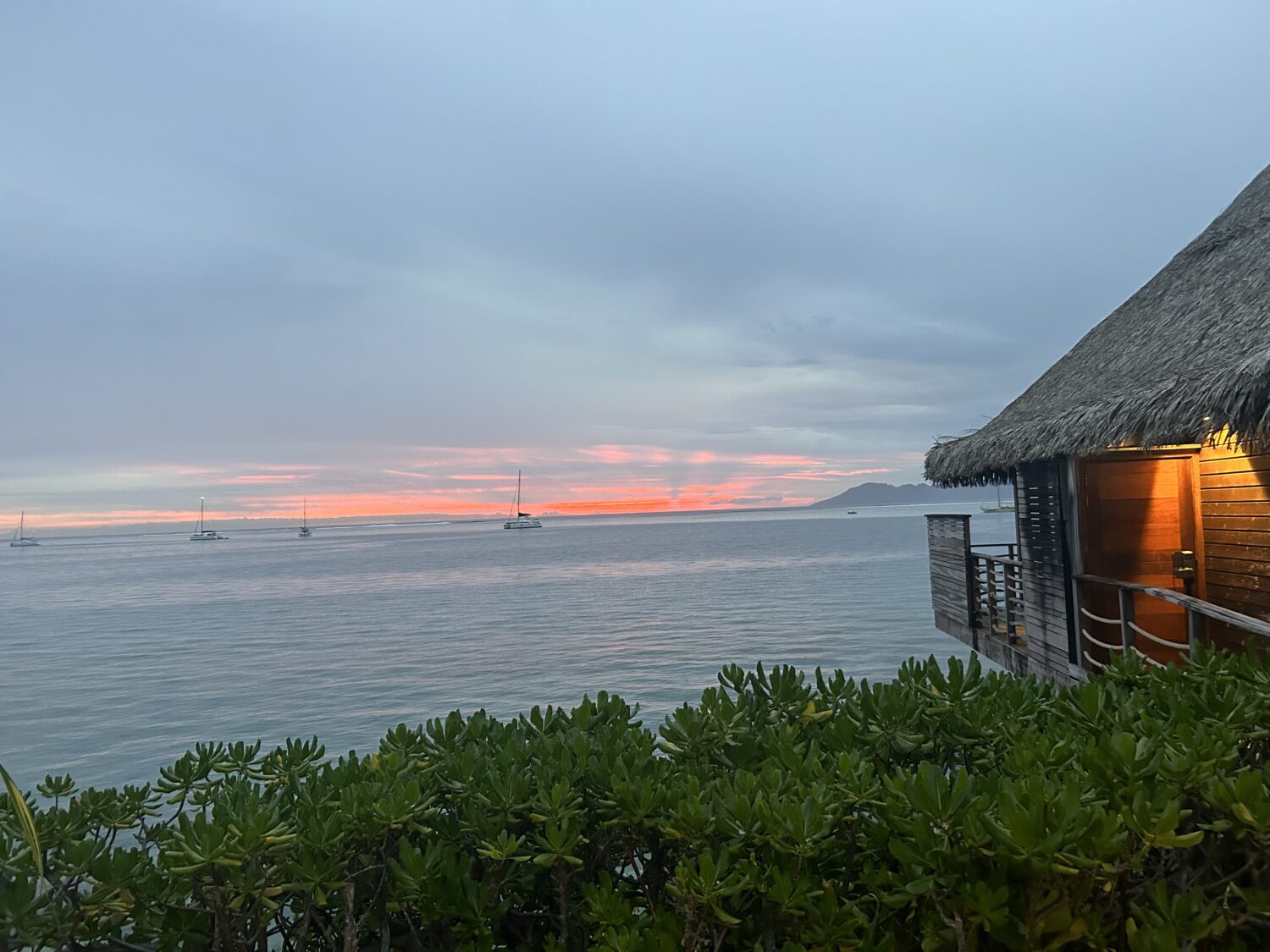 Overwater bungalow at sunset