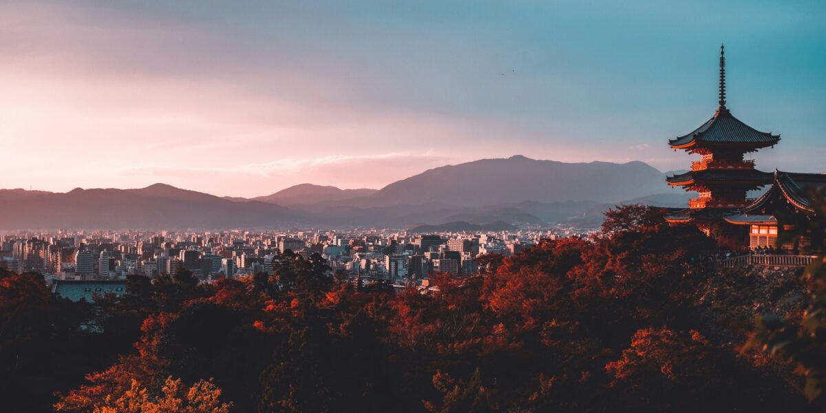 a temple in kyoto japan with mountains in the background