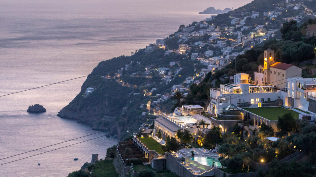 several white hotel buildings built into a hill