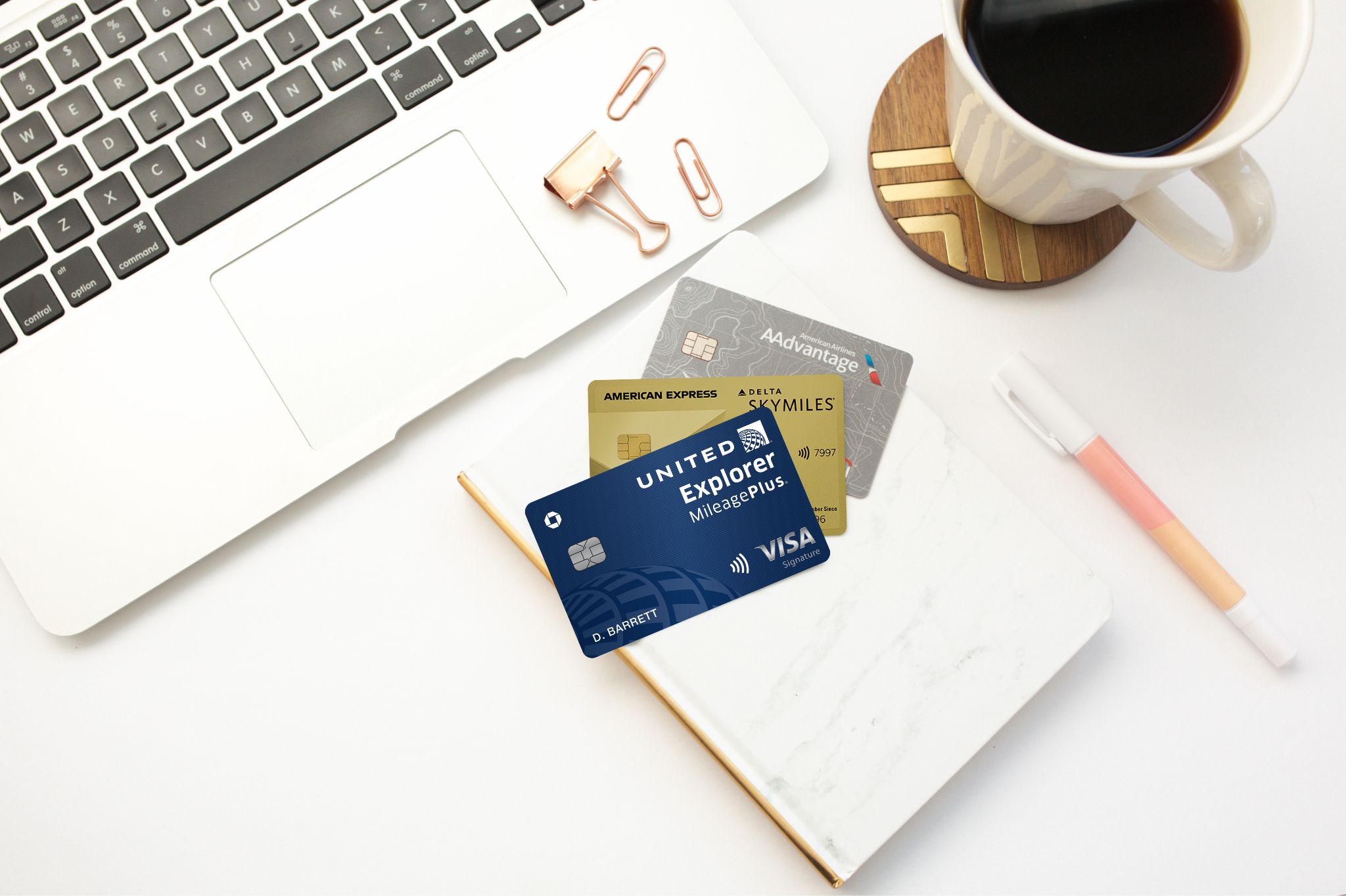 Losing Your Airline Status Next Year? Here's What You Can Do 4 United, Delta, and American Airlines credit cards with a laptop.