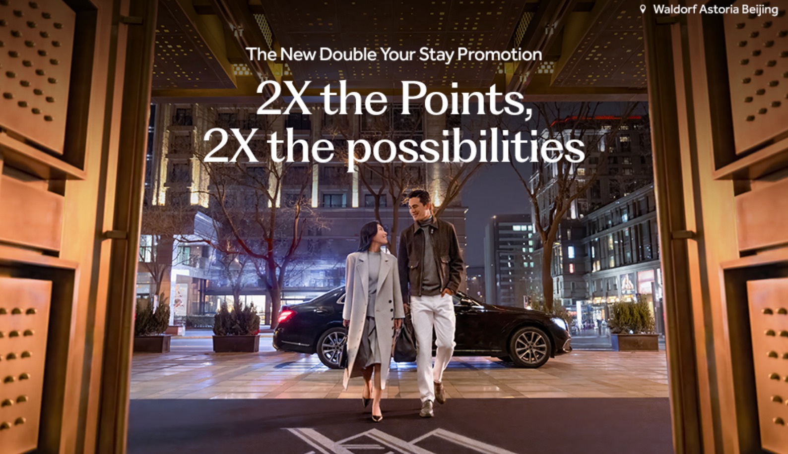 Register Now: Earn Double Points For Every Hilton Stay Next Year! 1 two people walking into a hotel door with a car behind them