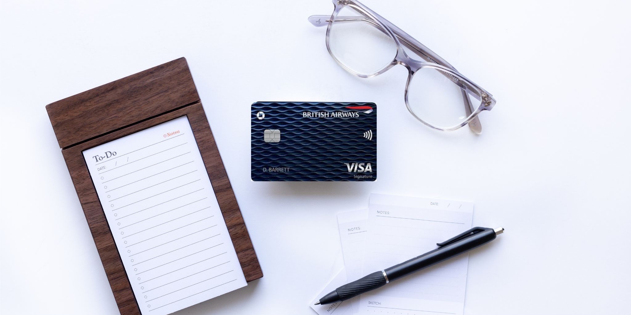 British Airways Credit Card with glasses, notepad, and pen