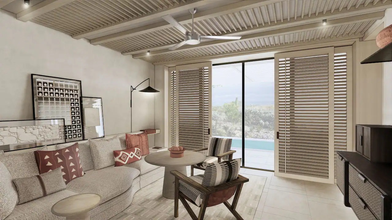 a living room in a hotel suite with lots of seating options and doors that open to a private plunge pool. 