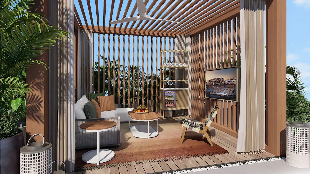poolside cabana with a tv, couch and mini bar