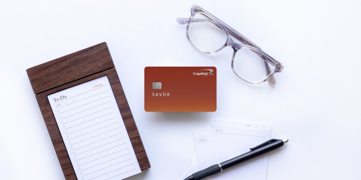 How to Combine Capital One Miles Between Cards & Other Cardmembers 8 Capital One Savor Rewards Card with glasses, pen, and notepad