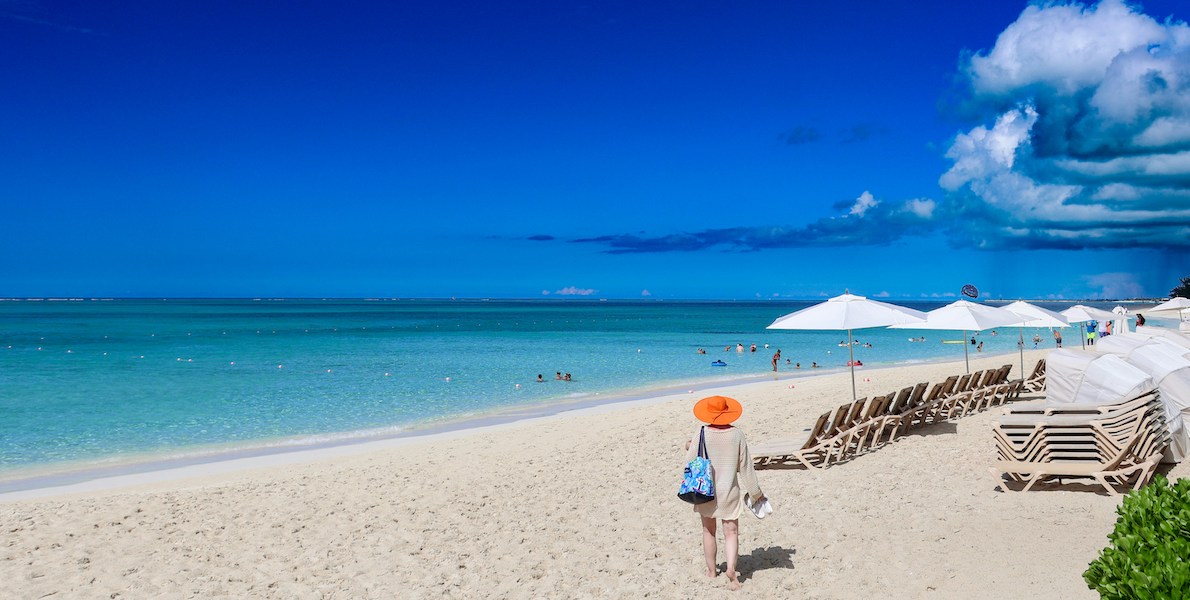 a person walking on a beach in turks and caicos