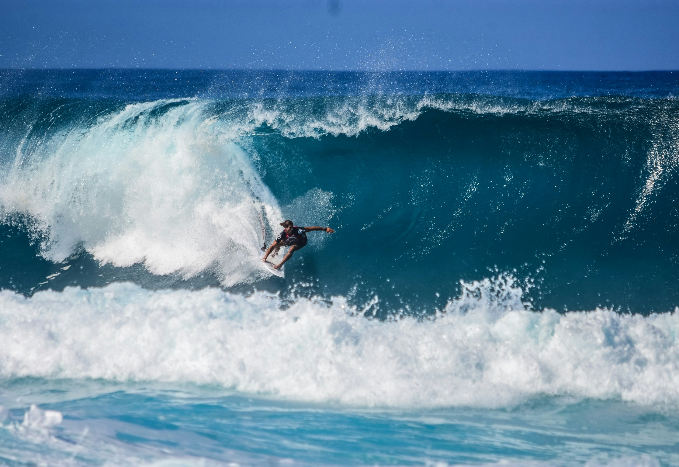 surfer catching a wave in hawaii
