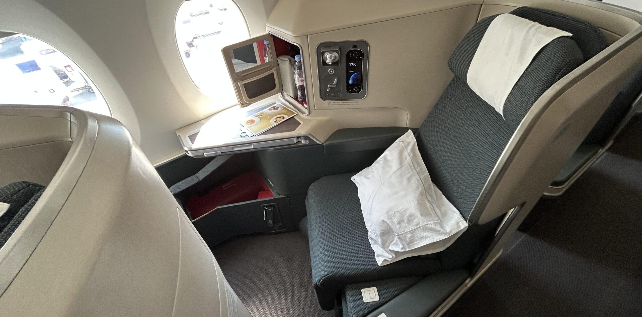 a green and white business class seat on an airplane