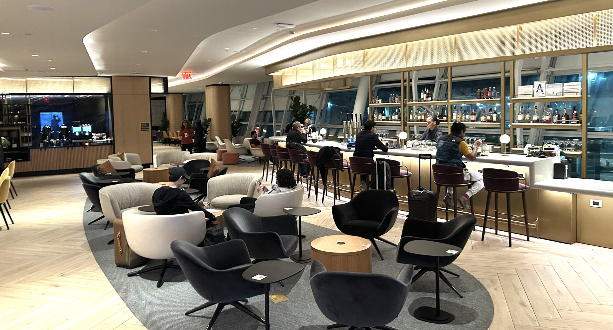 armchairs and a long bar inside the Chase Sapphire lounge at JFK Airport