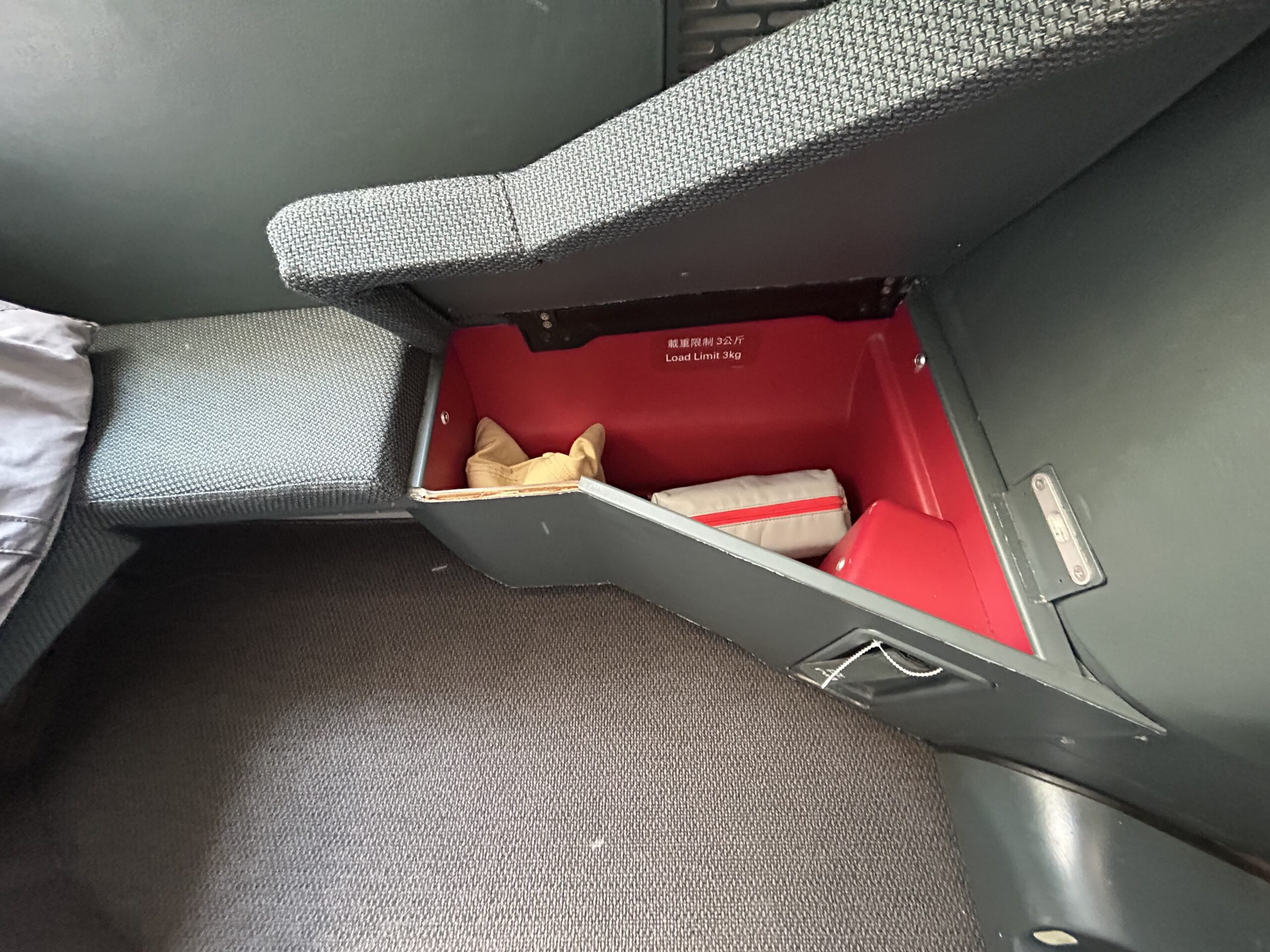 A cubby in a business class seat