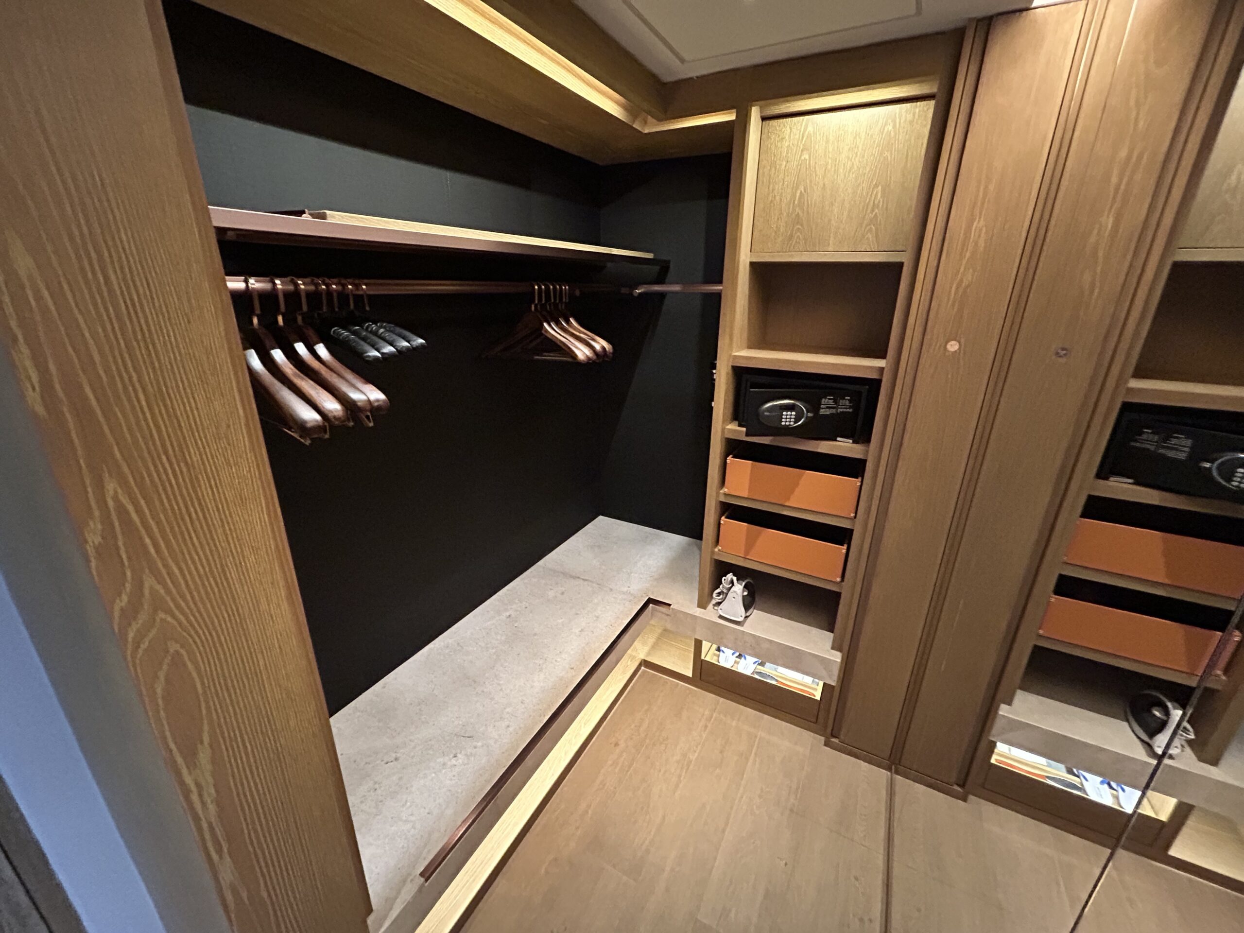 spacious closet with hangers and drawers in a hotel room