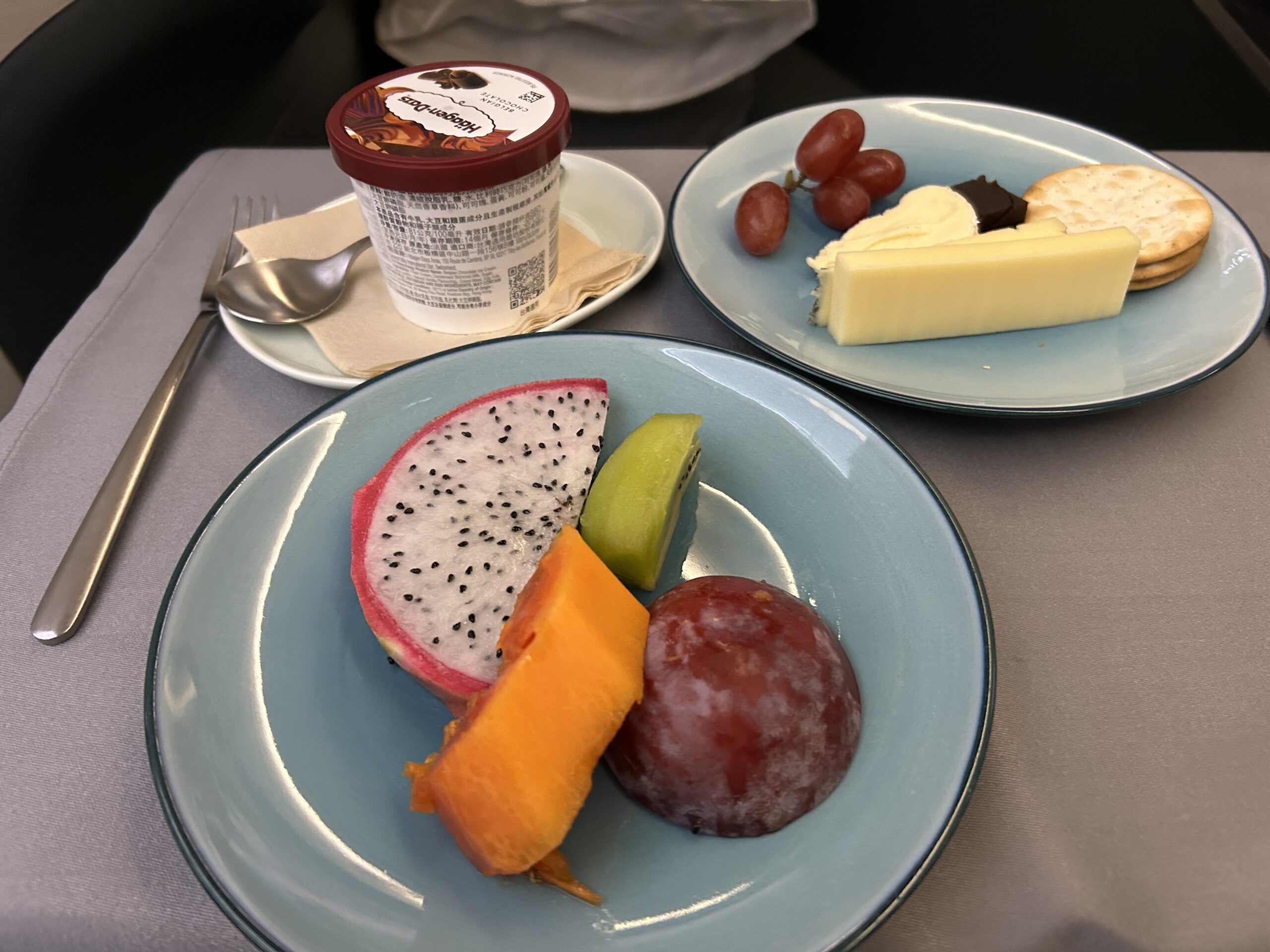 Plates with fruit, ice cream, and cheese and crackers