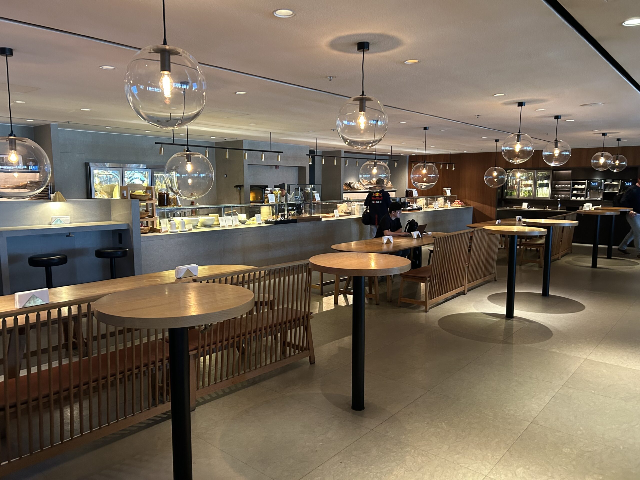 high top tables and a buffet in an airport lounge