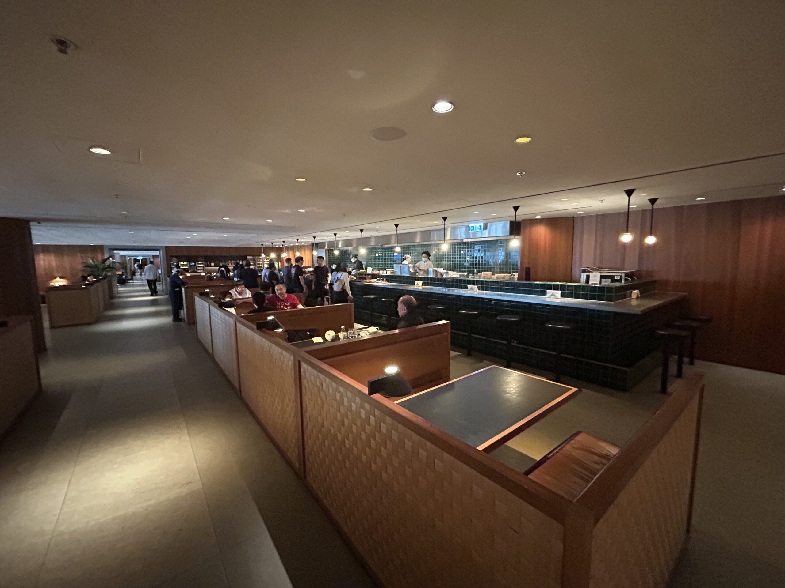 a row of booths inside an airport lounge 