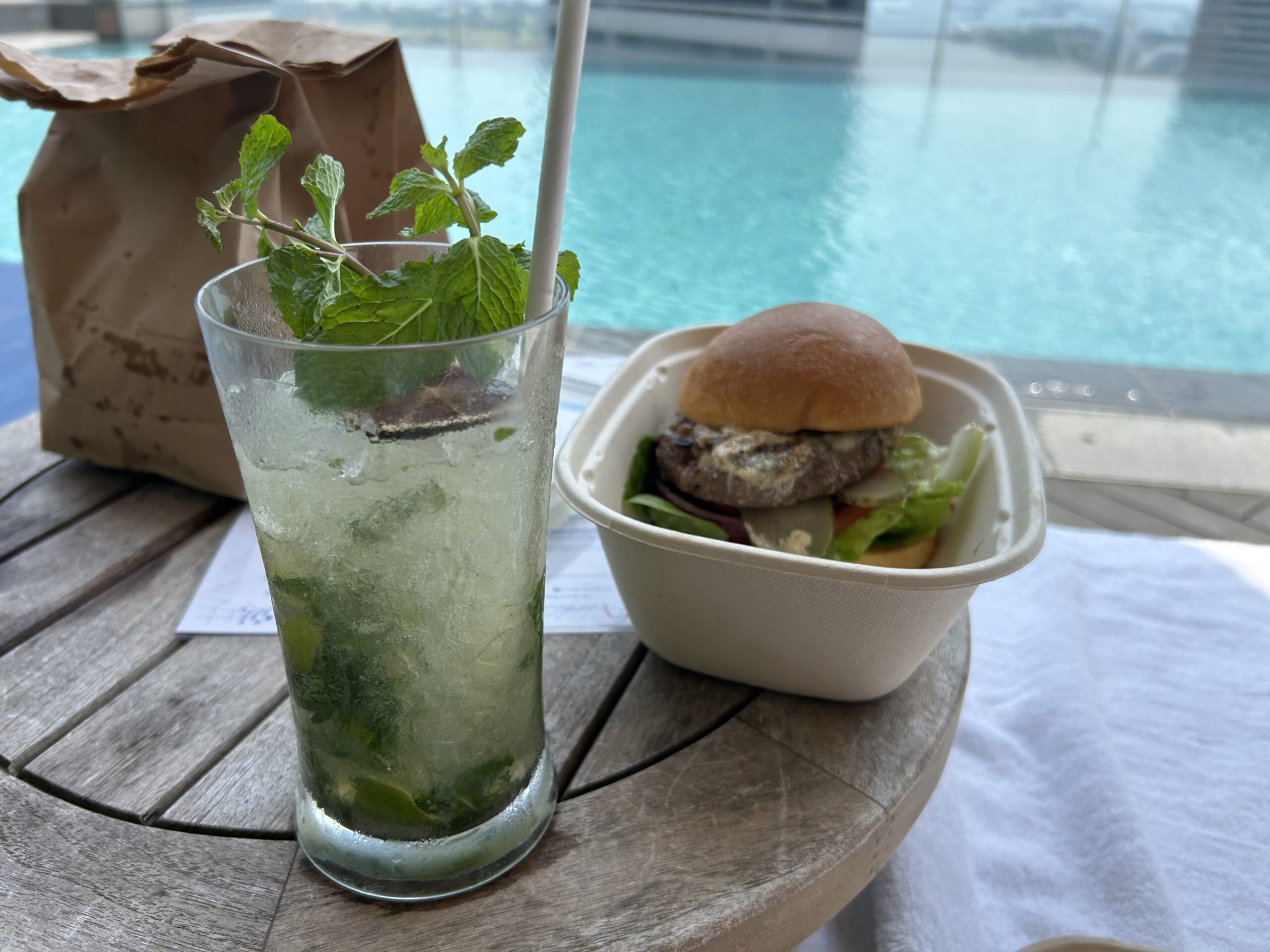 a burger and a mojito at the pool 