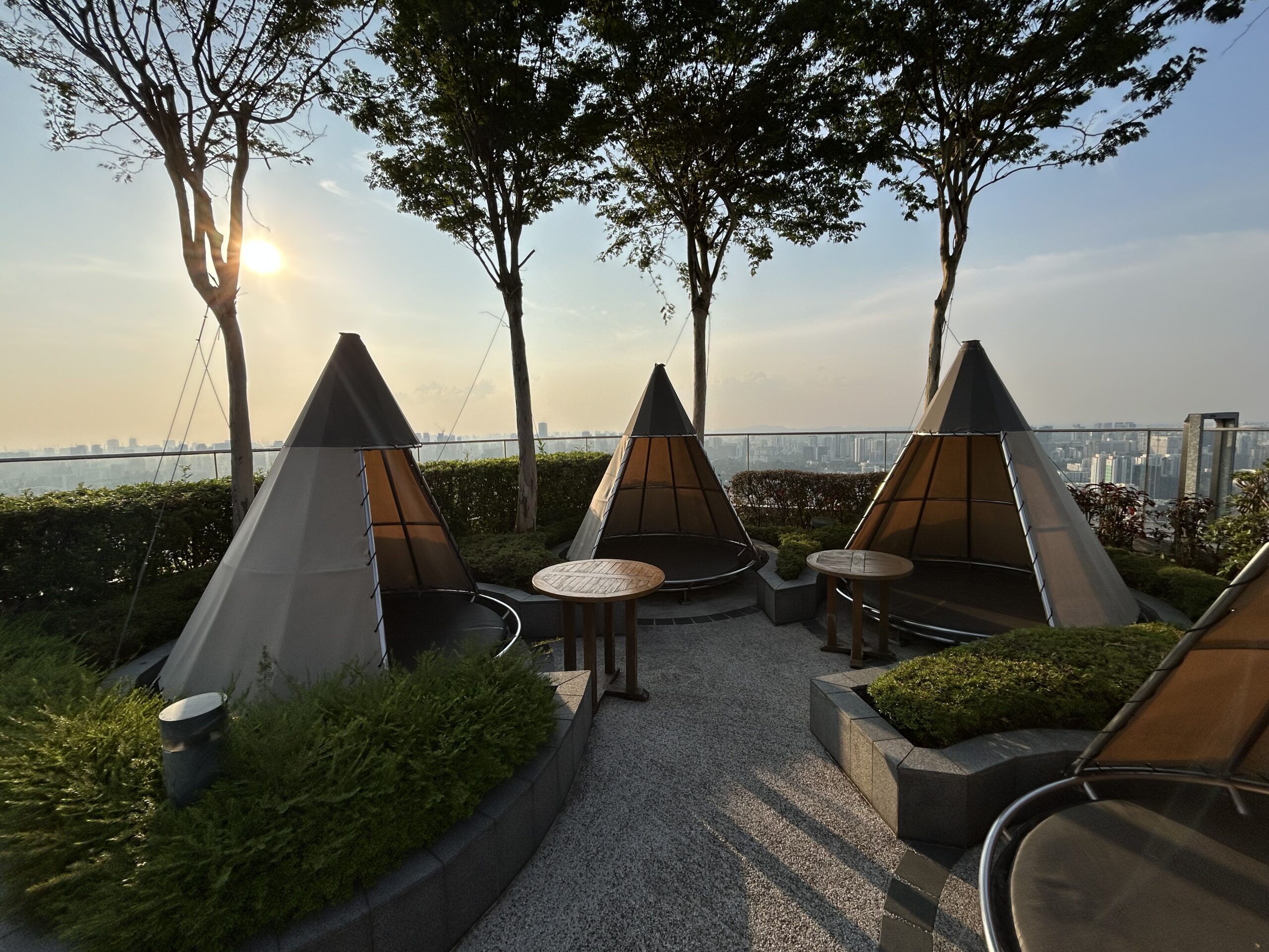 three teepees on the terrace of a hotel restaurant 