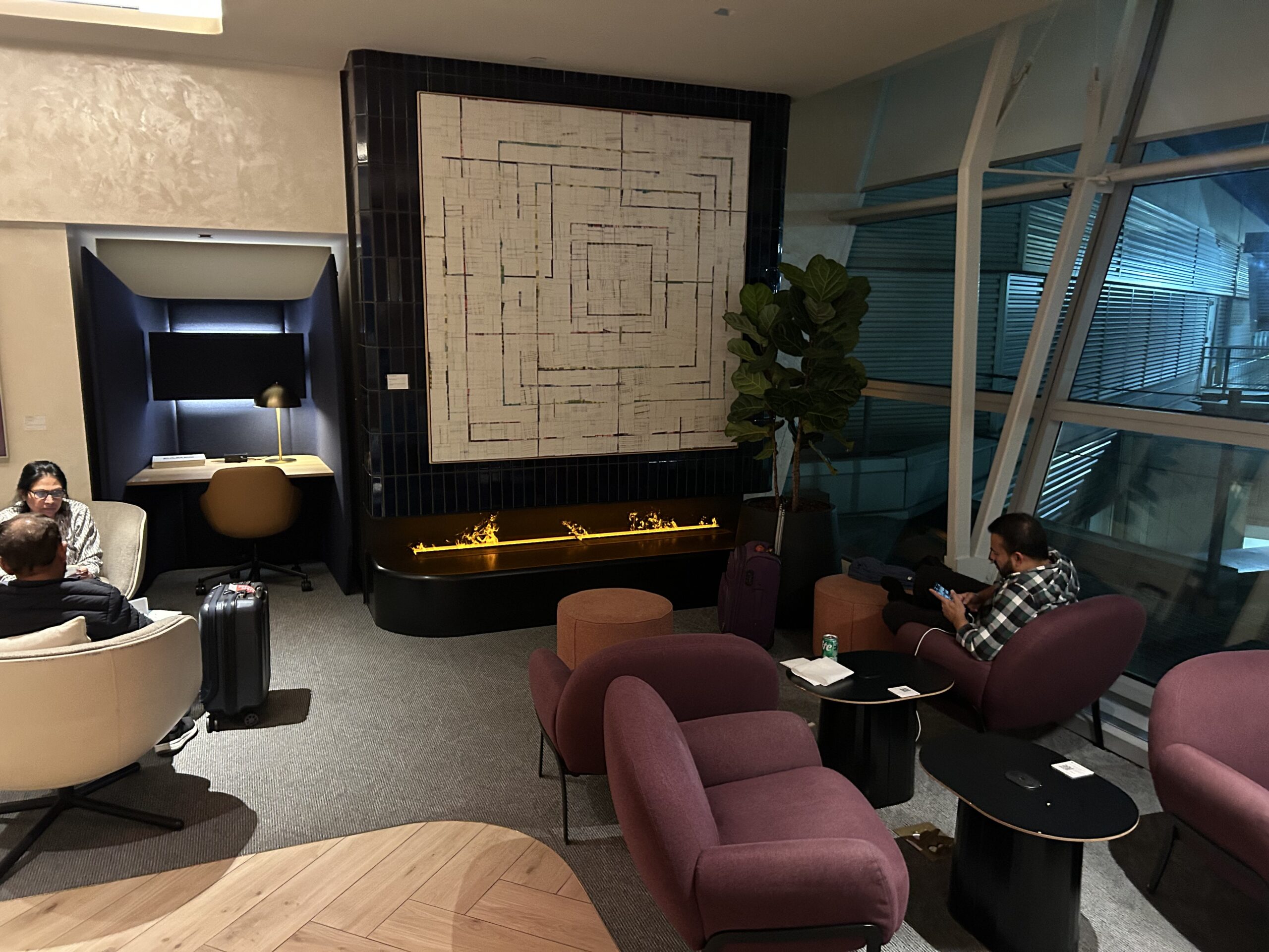 Fireplace seating in the back of an airport lounge