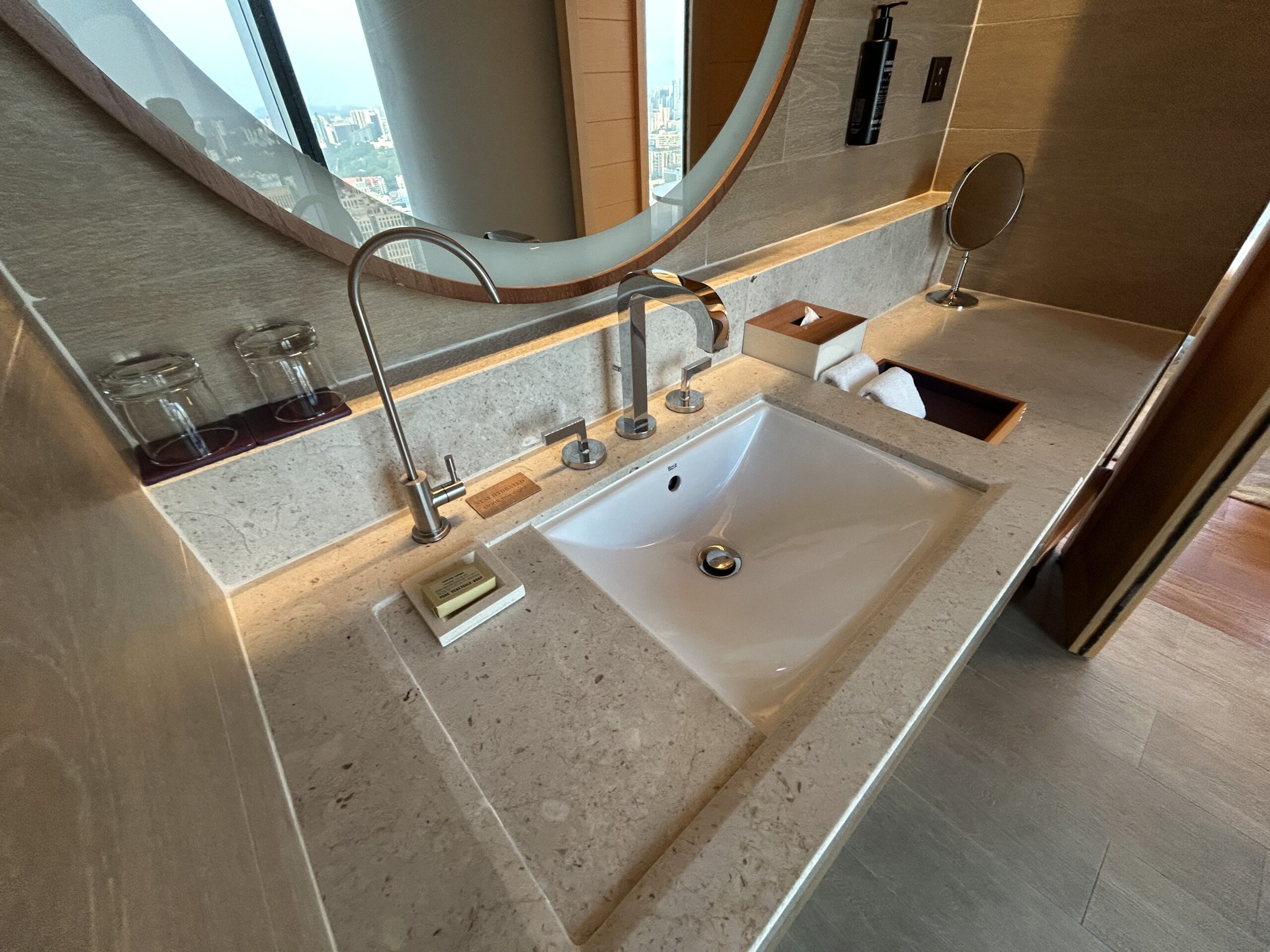 Sink with water bottle filling station in hotel room