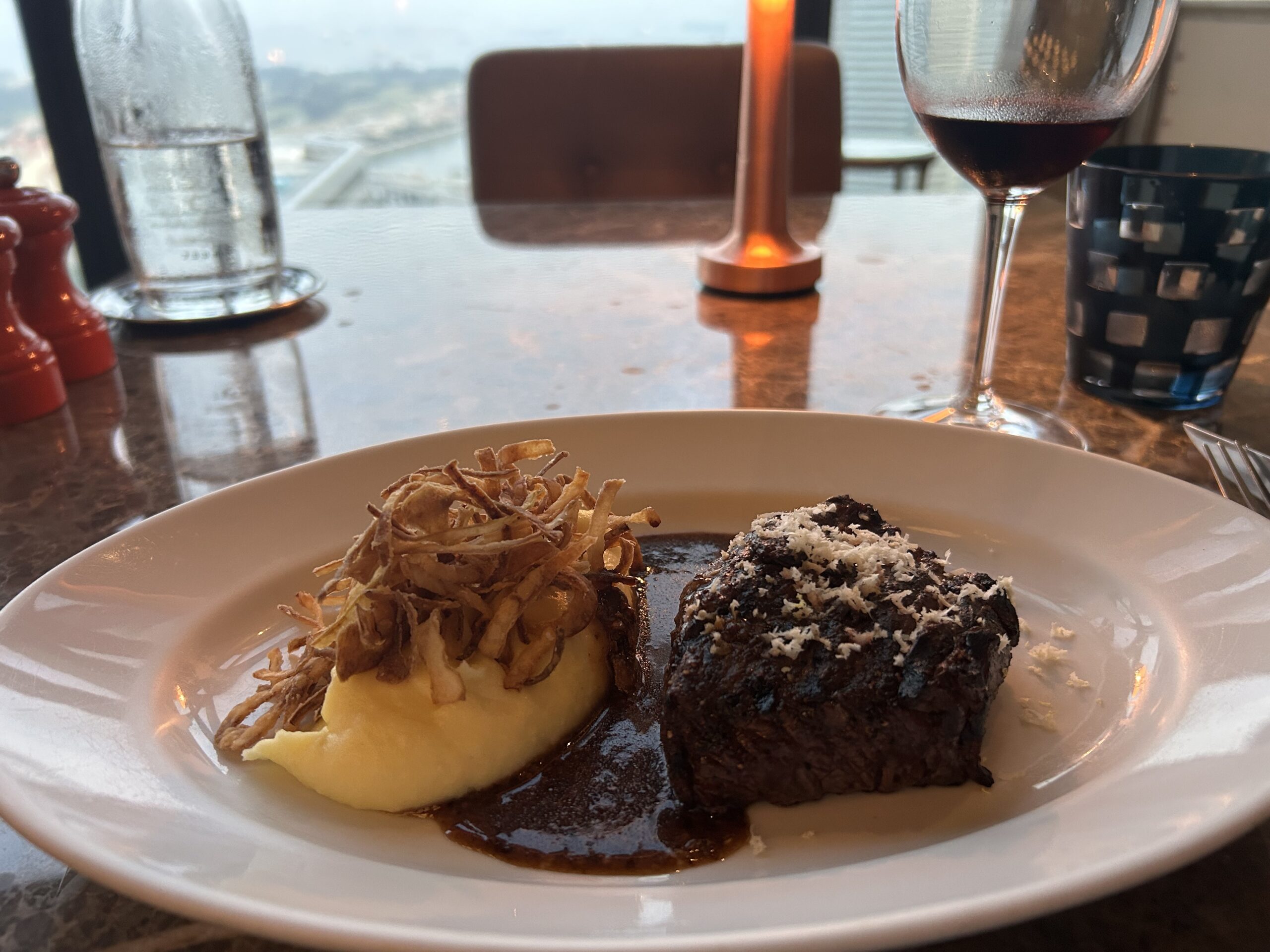 steak and potatoes with a glass of wine