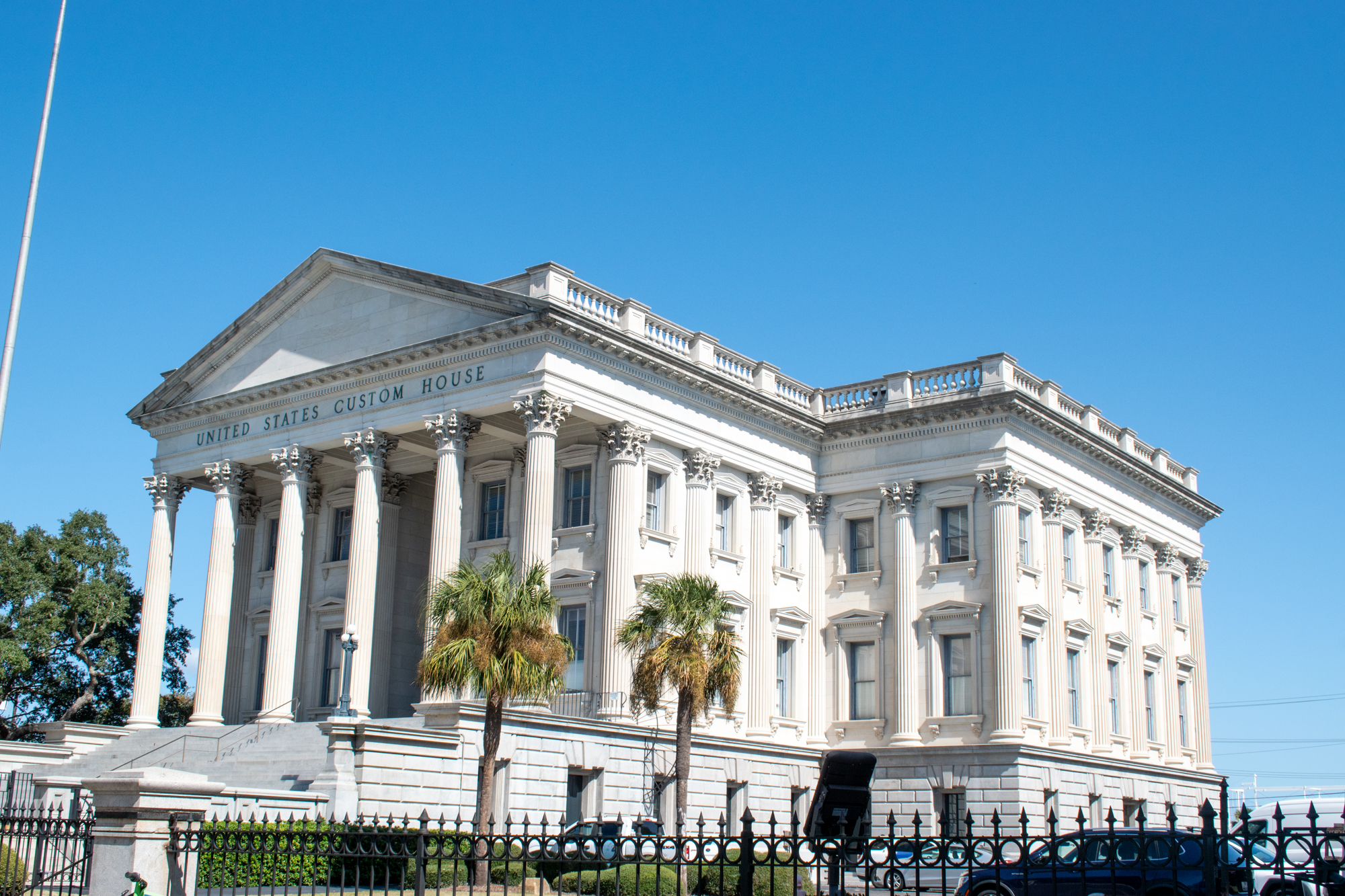 The U.S. Custom House in Charleston South Carolina. A big, white building with palm trees in the foreground. 