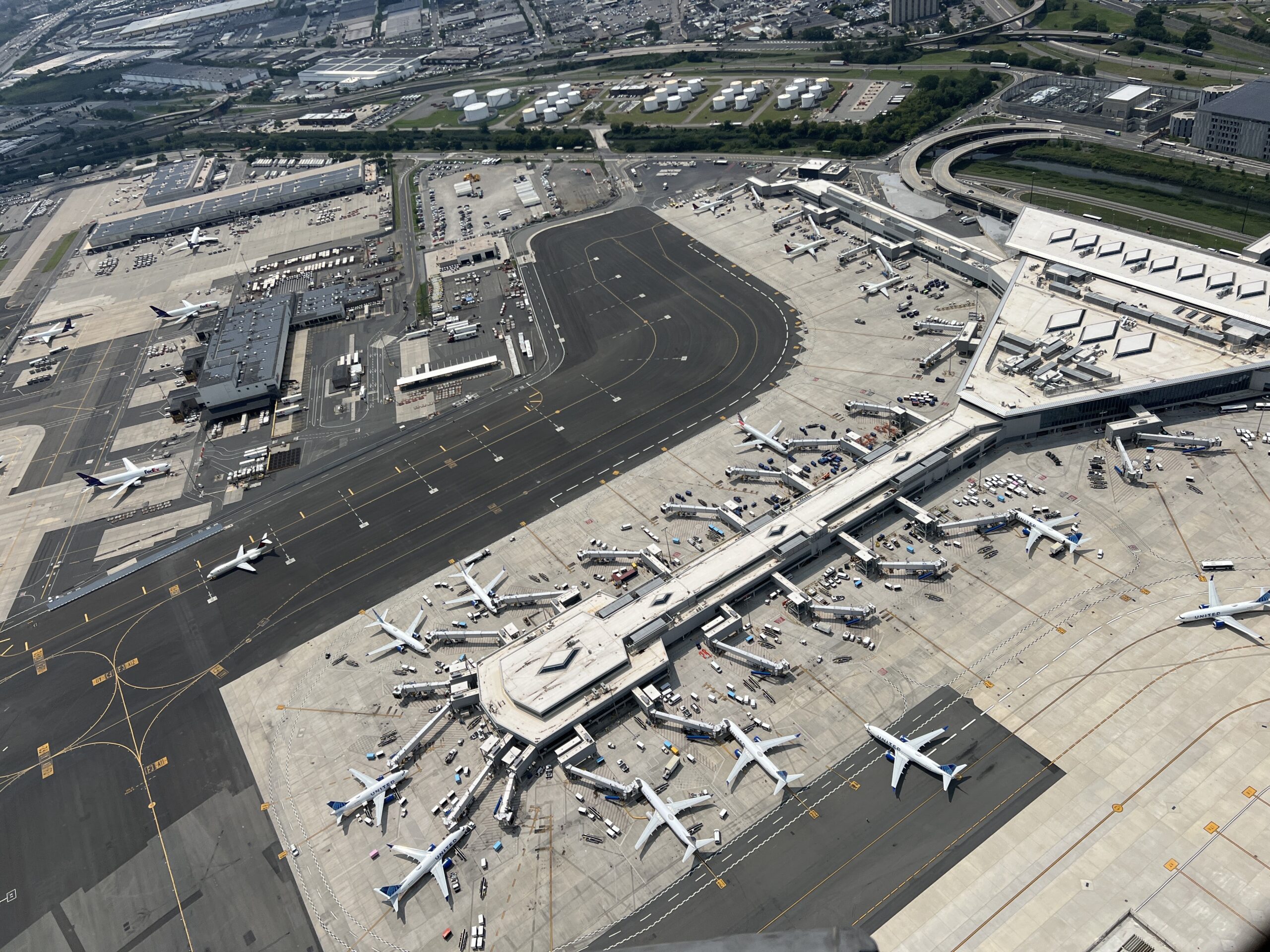 an airport from overhead with many planes parked at gates