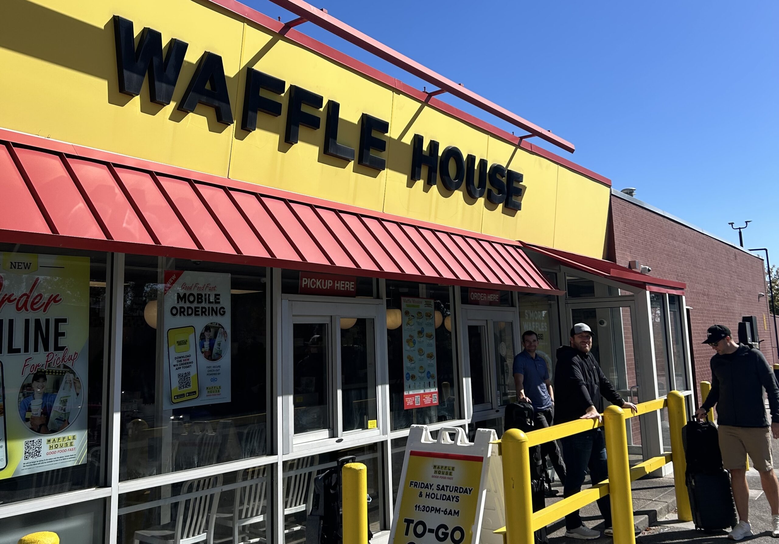 Weary travelers stand outside of a Waffle House near the Charleston Airport awaiting their uber to the city. 