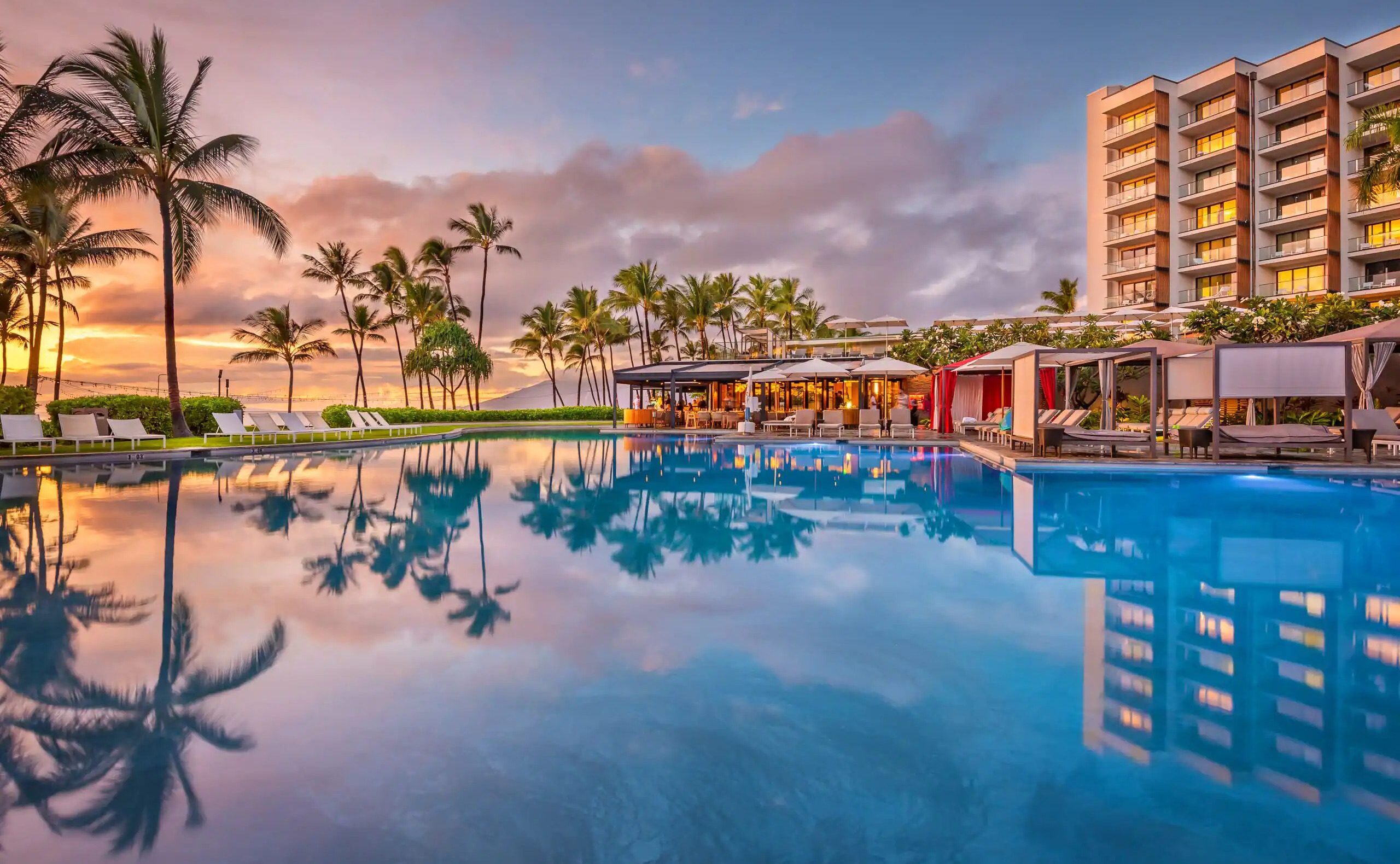 12 of the Best Domestic Hotels You Can Book with Points 1 a pool with cabanas and a hotel building in the background