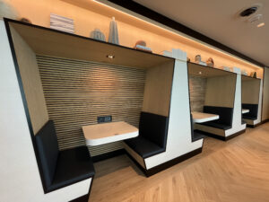 booths with tables inside of them and decorative wooden walls