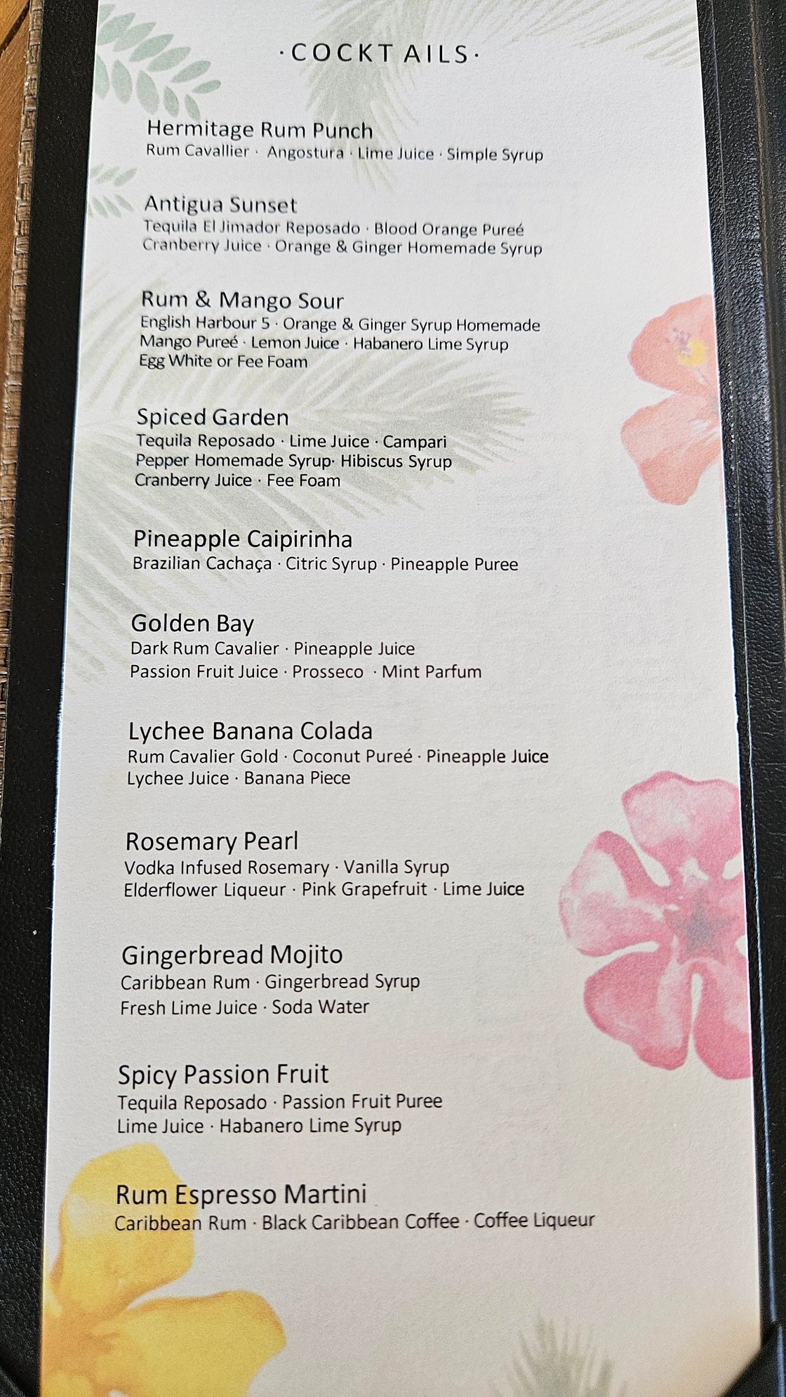 a paper cocktail menu with 11 drink options and their ingredients