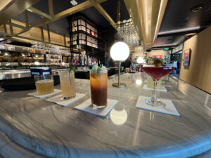 a bar with four different cocktails on display