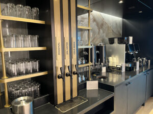 a tap with several drinks and glasses and gold accents