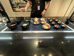 several breakfast dishes with an employee serving