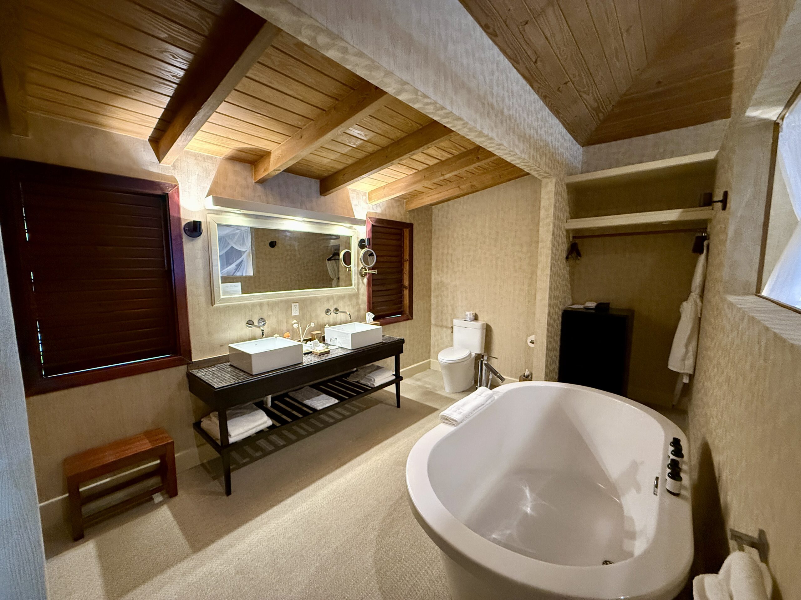 bathroom with a double vanity and soaking bathtub