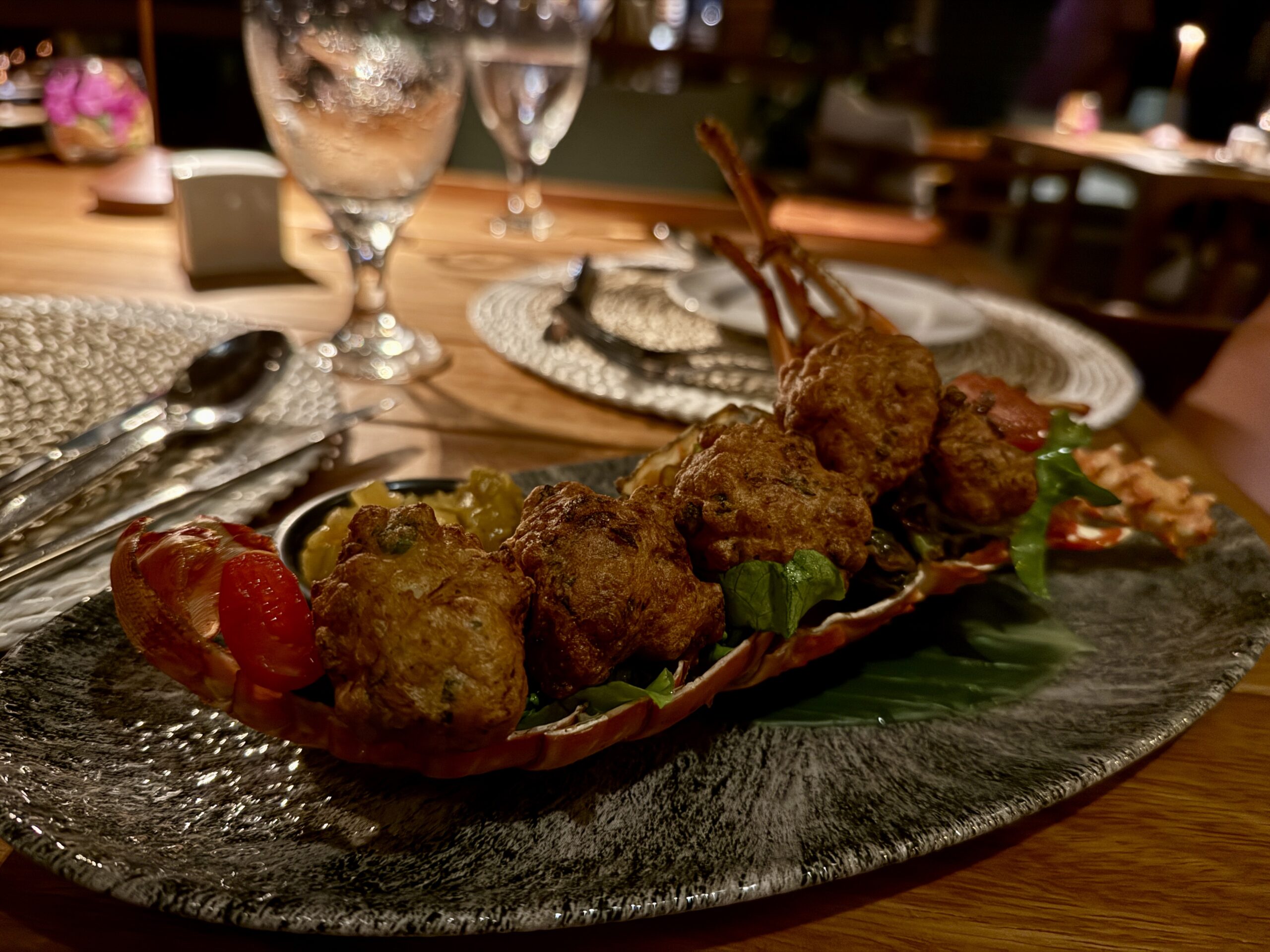 deep fried fritters sitting inside of a lobster shell