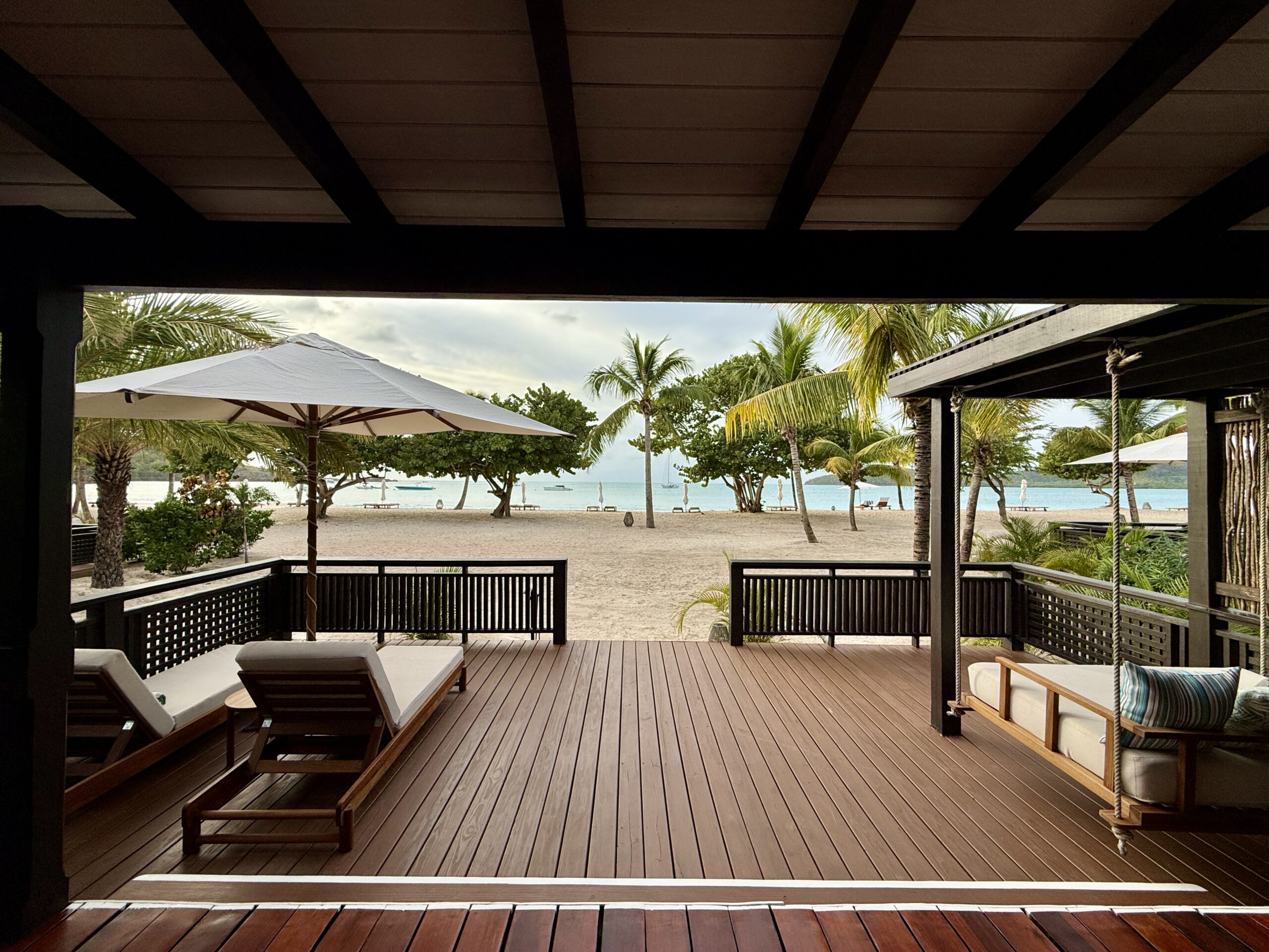 large outdoor deck with chairs and swinging bed