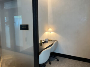 a quiet phone room with two chairs at a desk