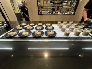 several black dishes and clear glasses
