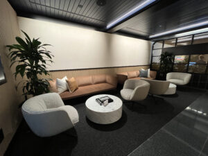 a dark room with several sofas and chairs