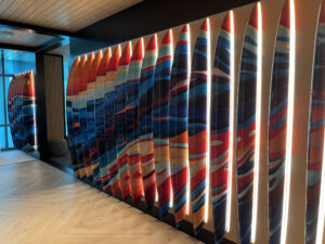 a wall of surfboards illuminated by light