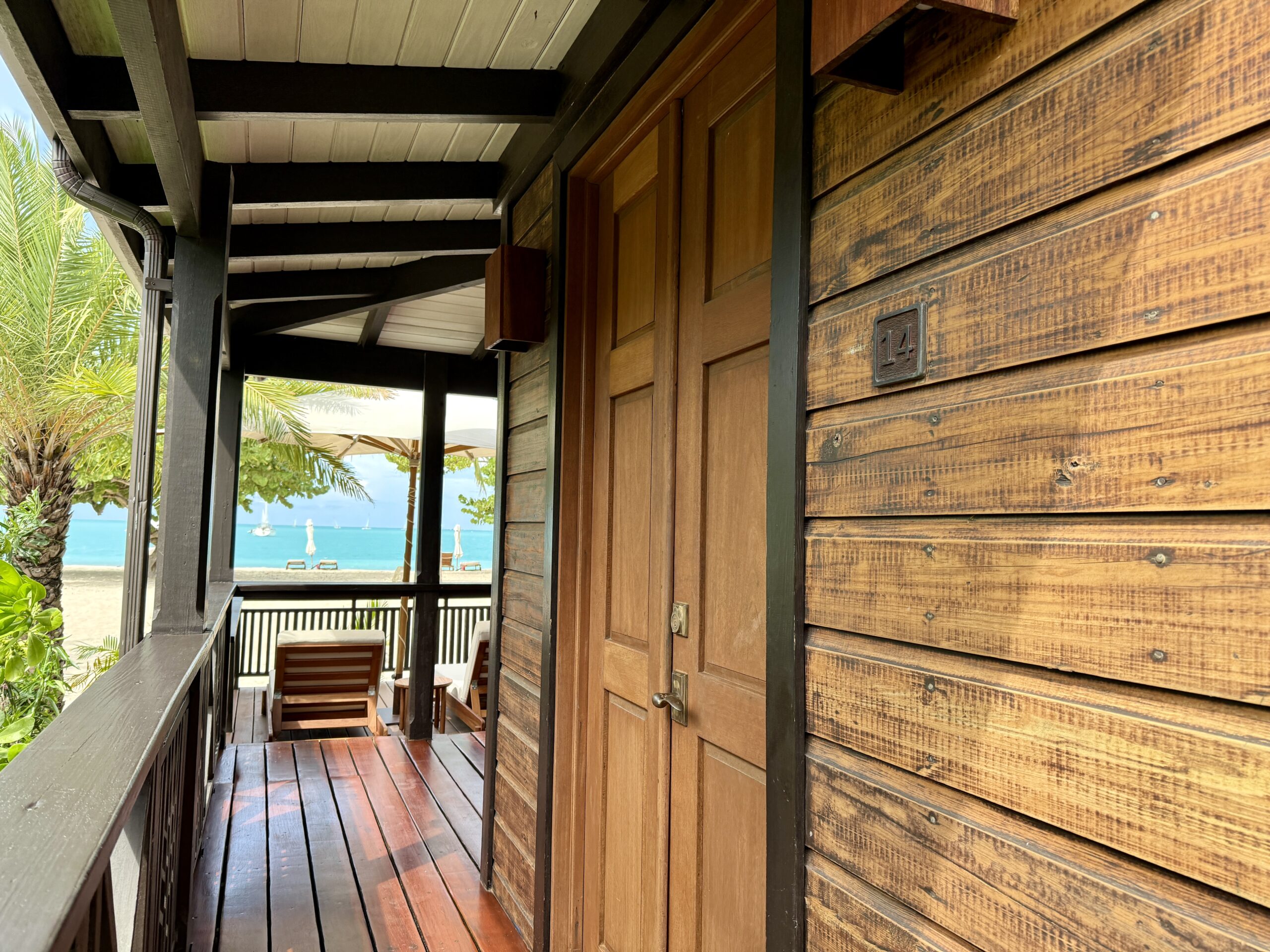 wooden villa doors with ocean in the background