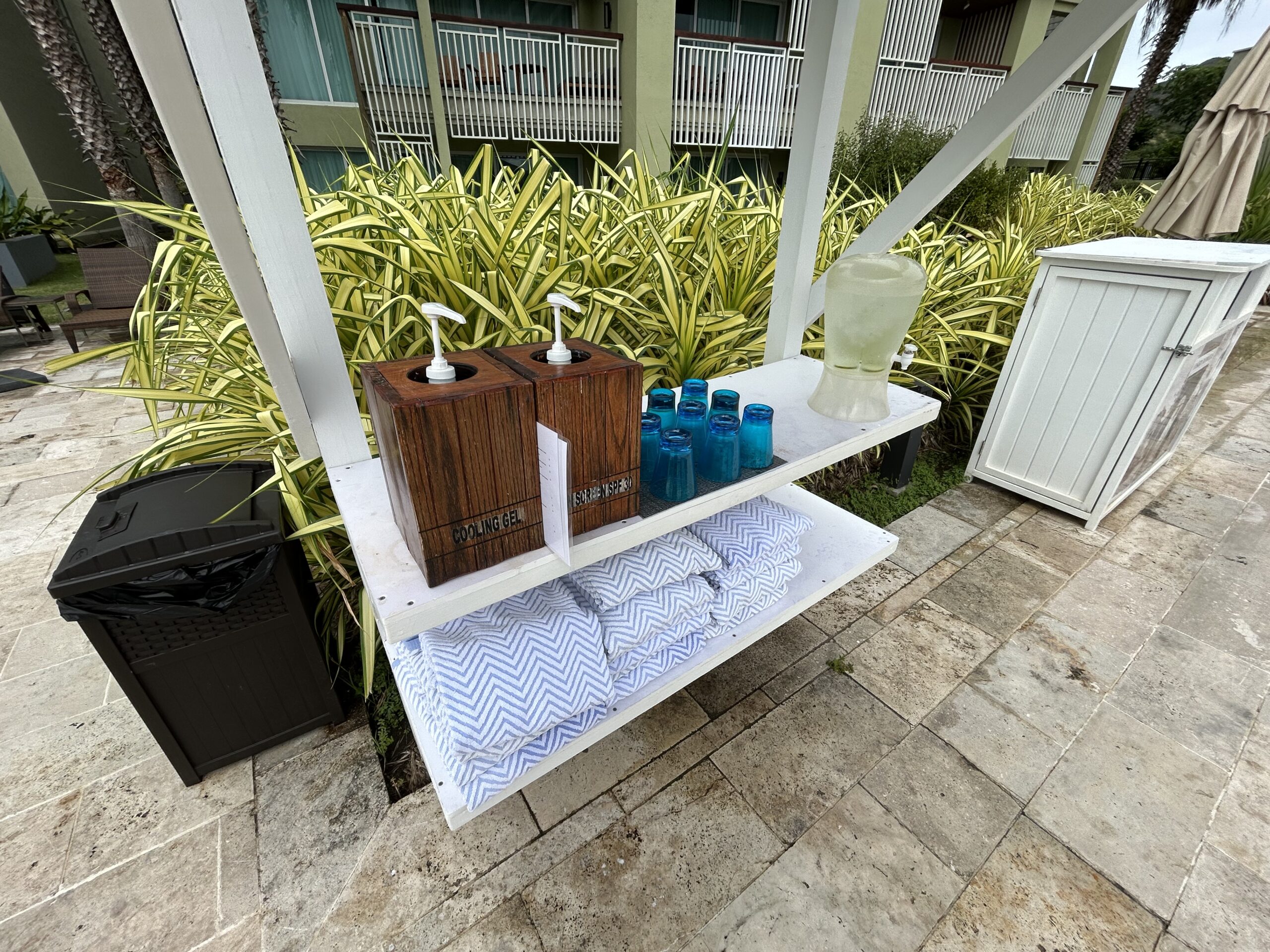 Cooling gel and sunscreen dispensers poolside. 