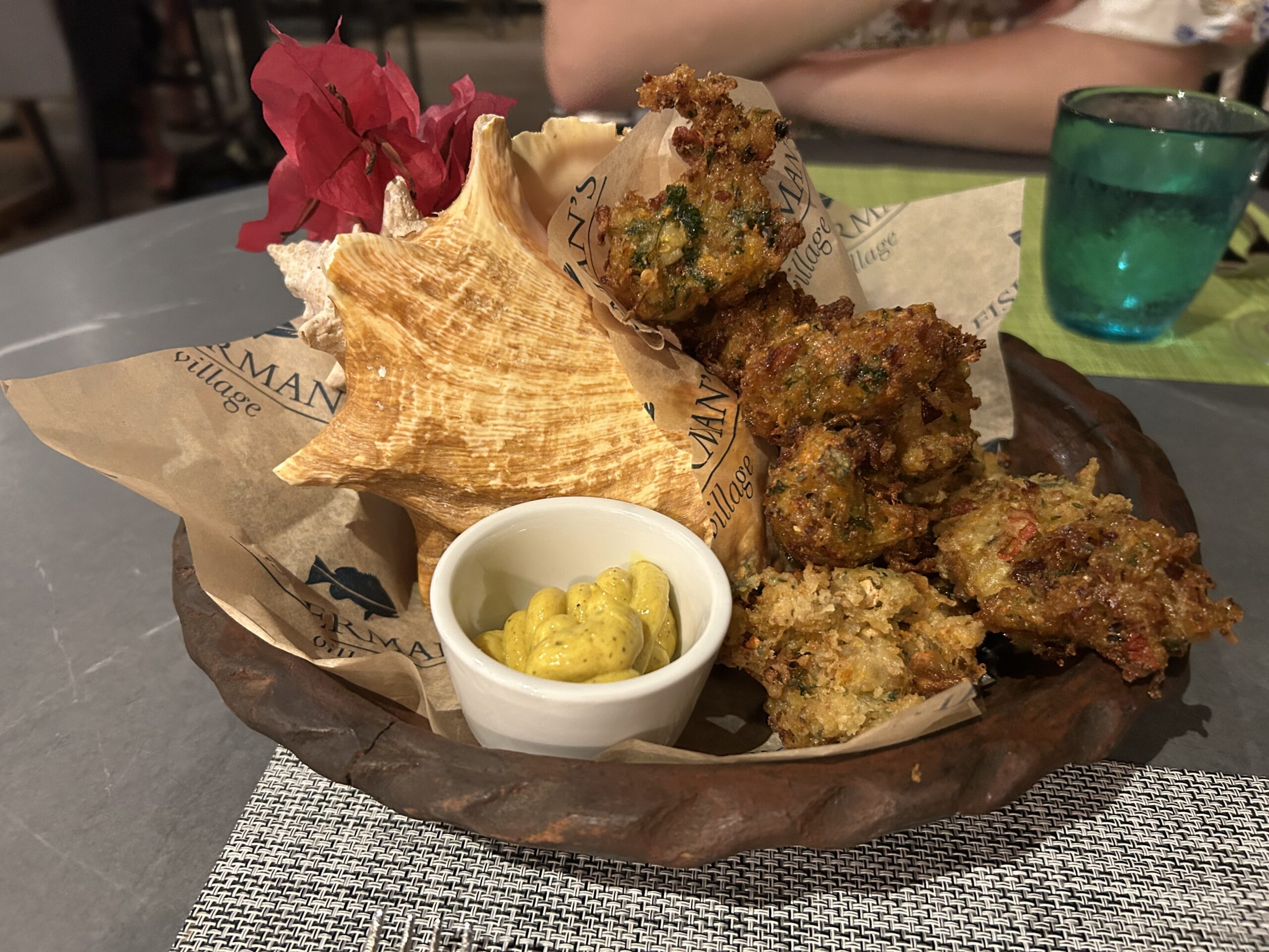 fritters with a conch shell on the plate